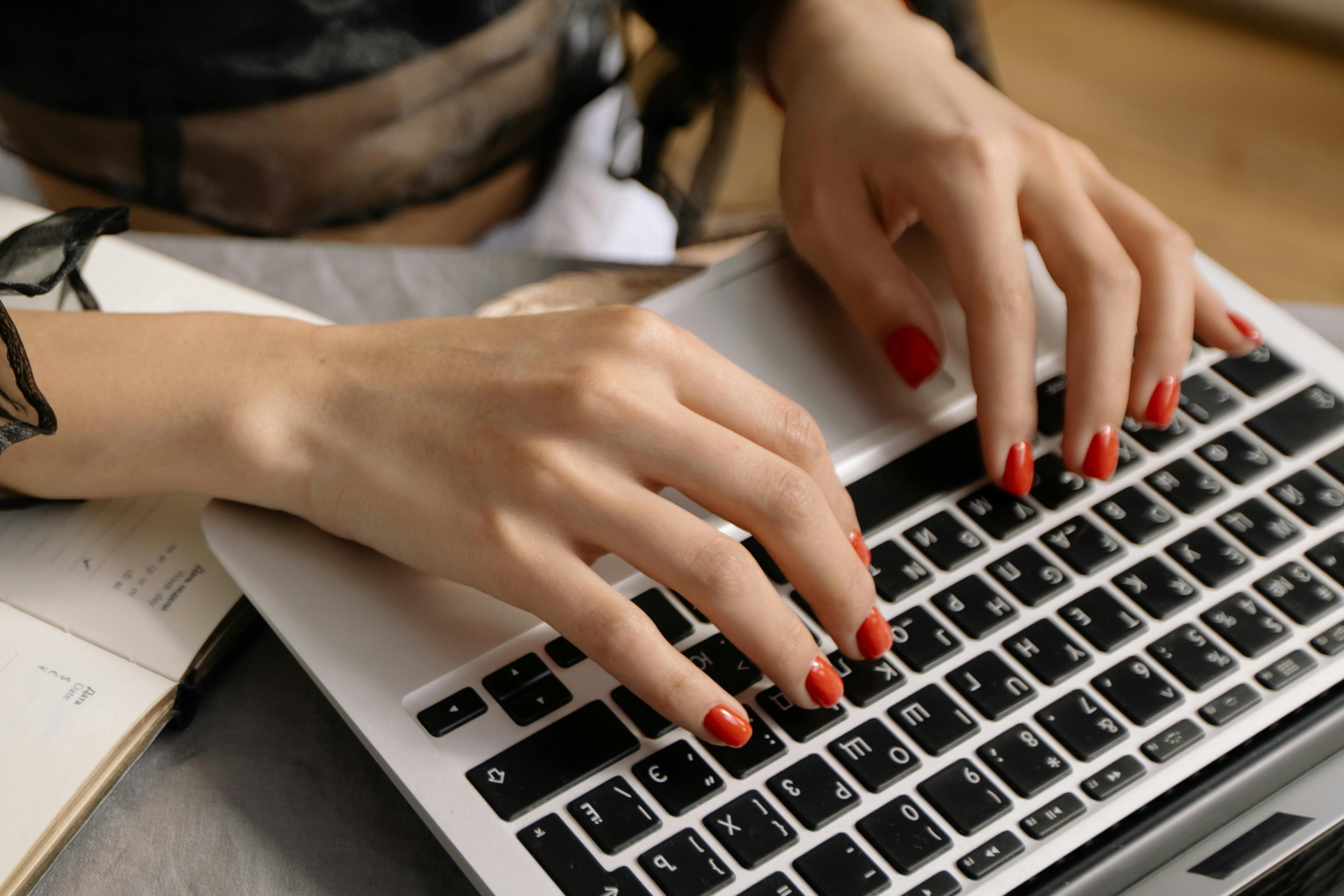 Woman with orange fingernails subscribing to Salesforce tutorials